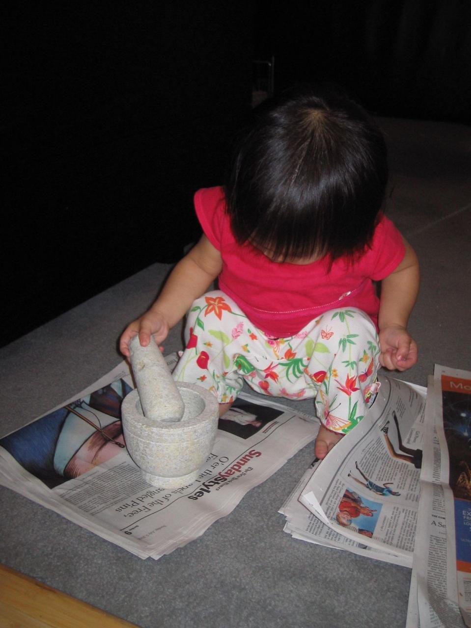 My daughter, a sixth-generation, learning to pound like a real Nonya.